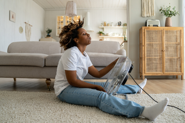 woman cooling off from hot flash